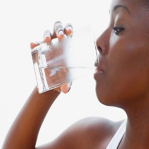 black woman drinking water